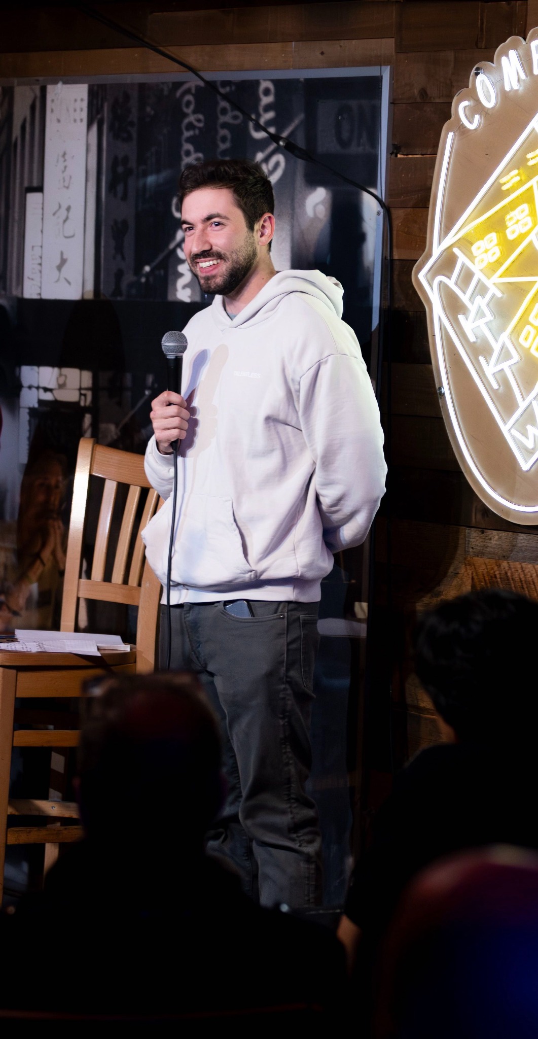 DiMaggio Comfort performing stand-up comedy on stage